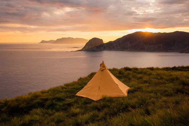 Nordic tipi canvas Olivin cp pitched by the sea in sunset