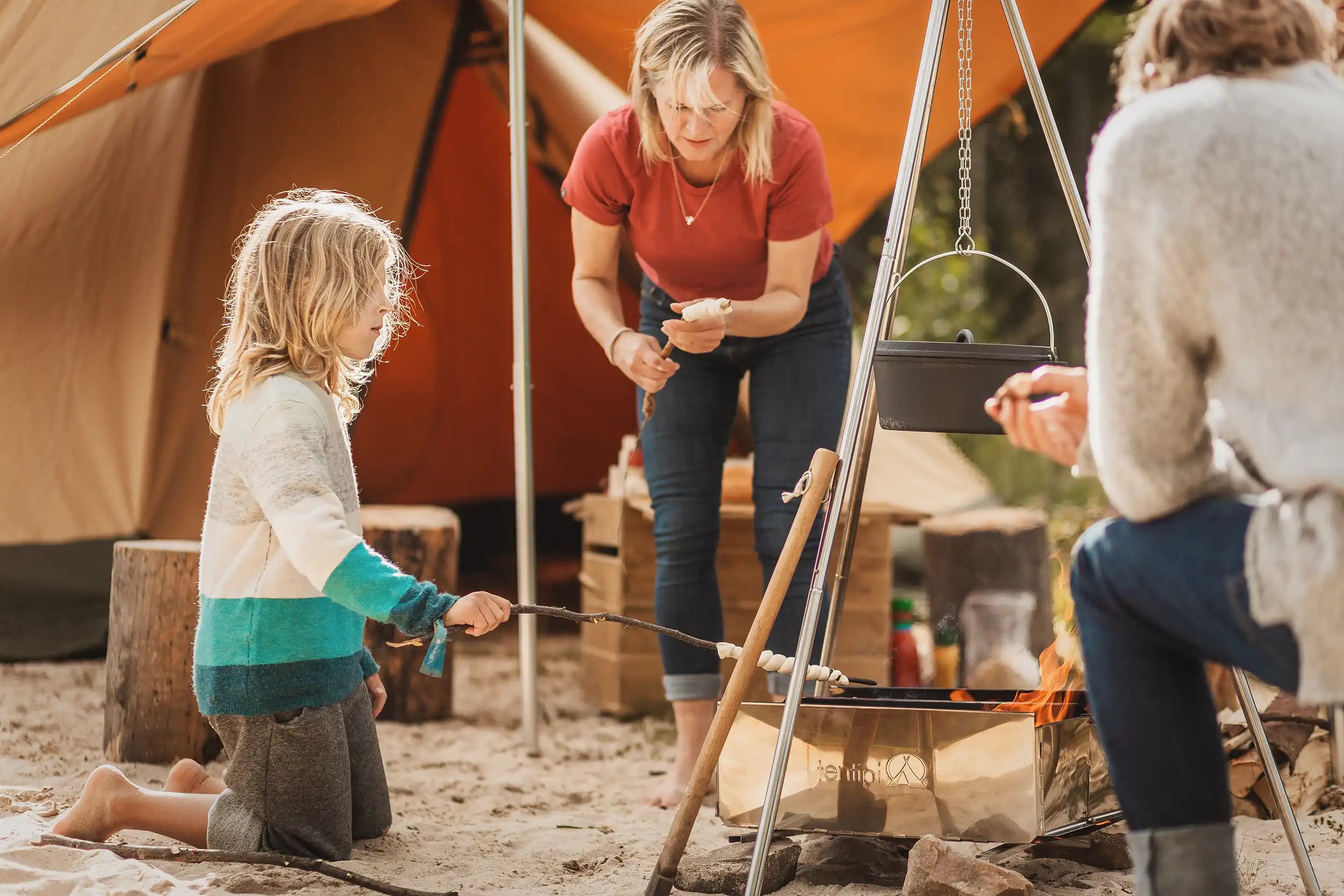 Family camping with plenty of room inside tent and shaded area outside for cooking and eating