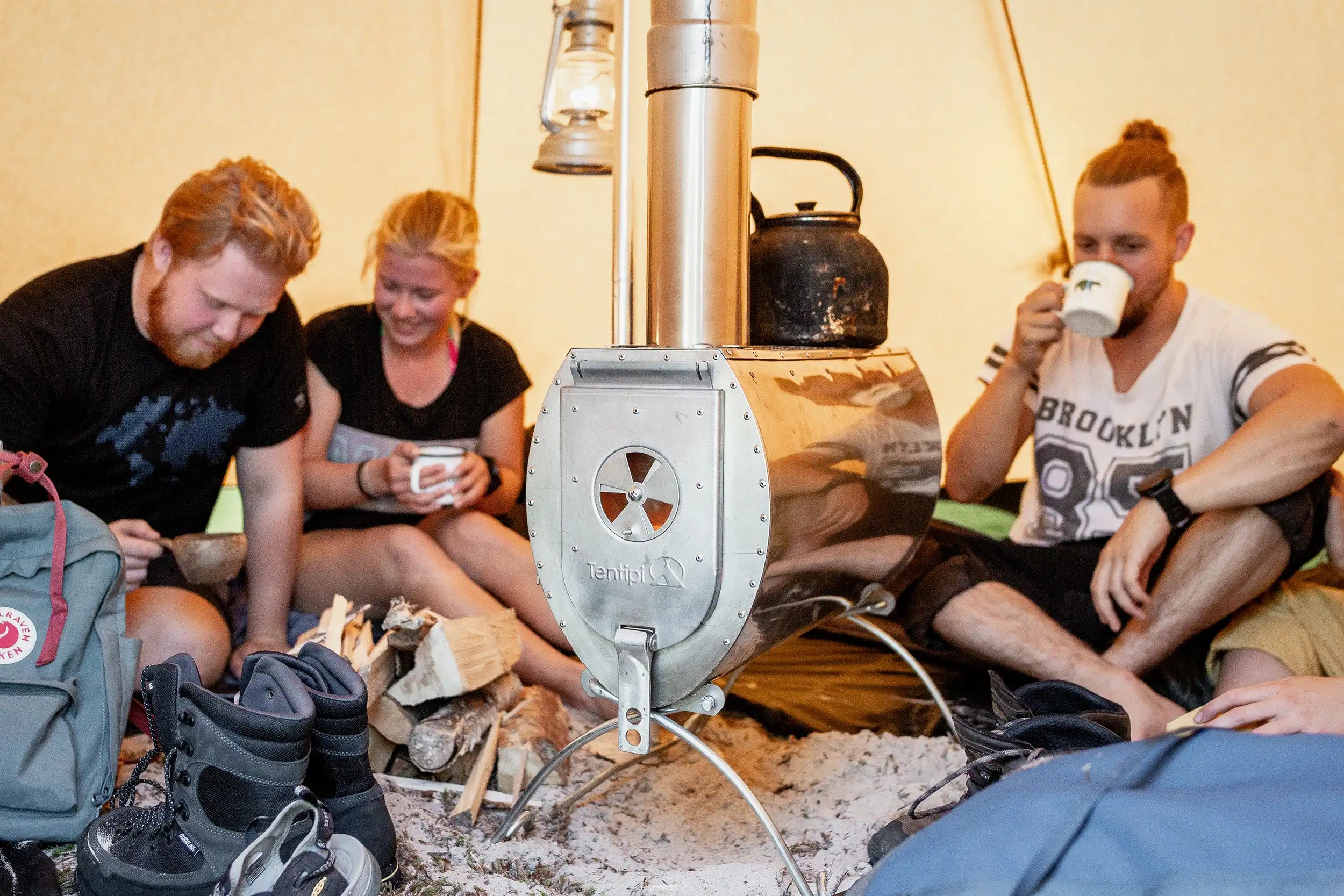 A tent with a wood burning stove for heating and cooking