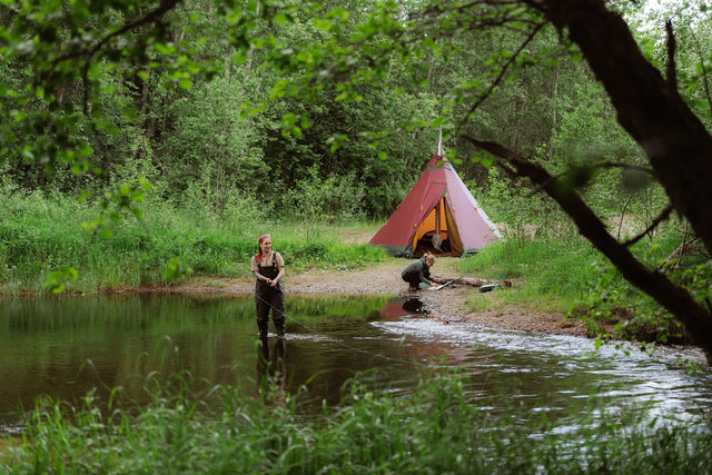 Two girls on fishing adventure with lightweight tent Zirkon 7 light with inner tent and wood burning stove